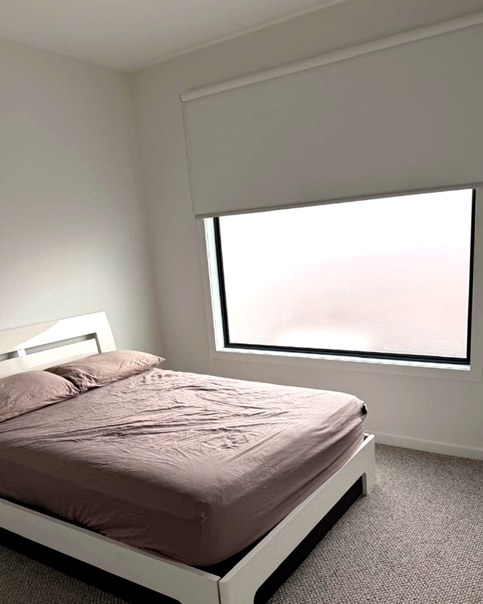 White roller blind in a Melbourne bedroom